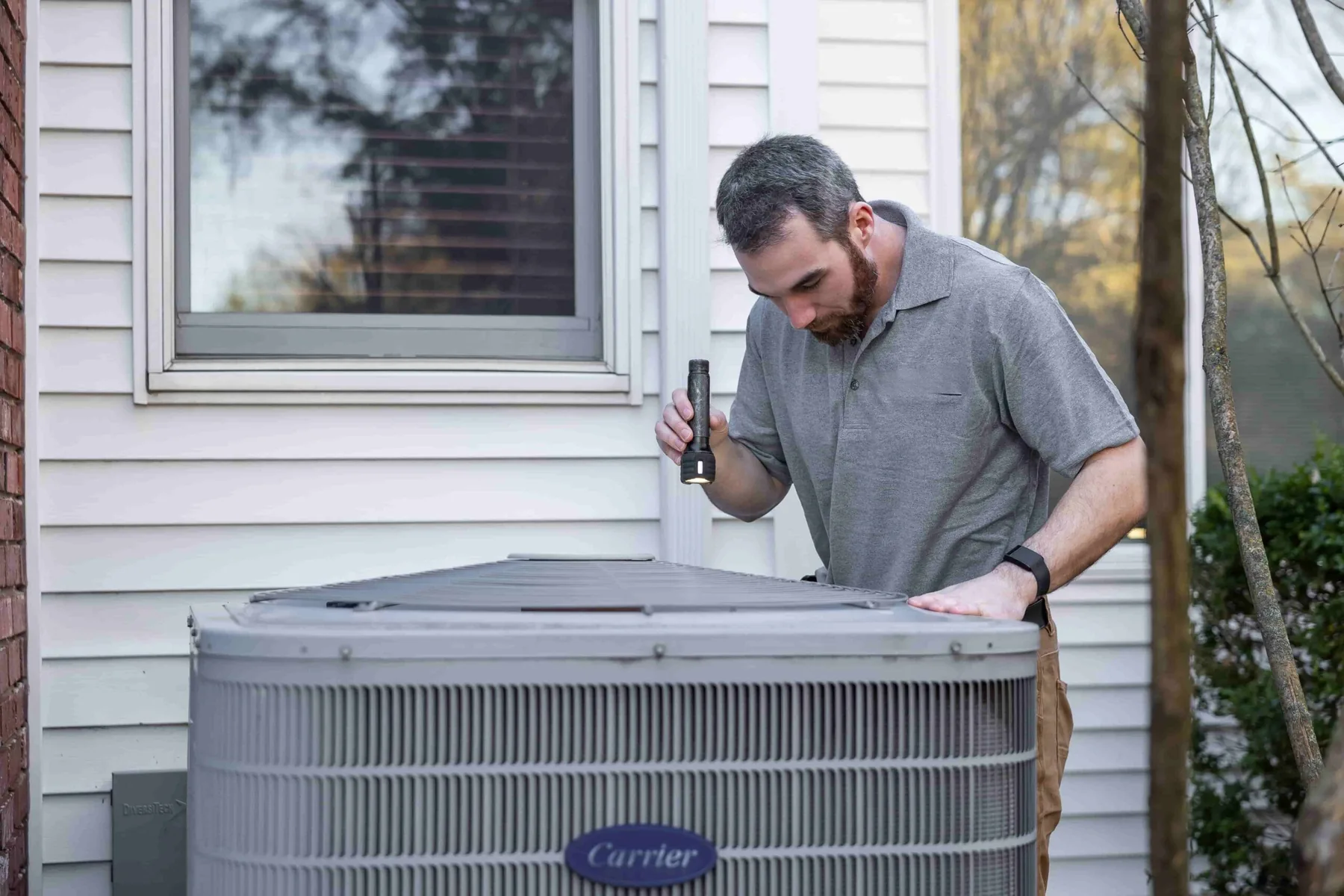 HVAC technician inspecting outdoor equipment